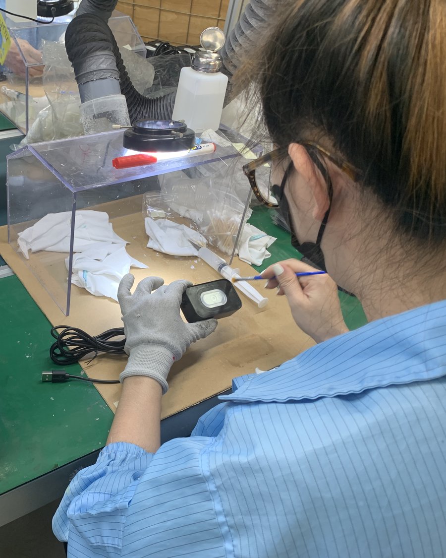 A Meritronics technician inspecting a finished device